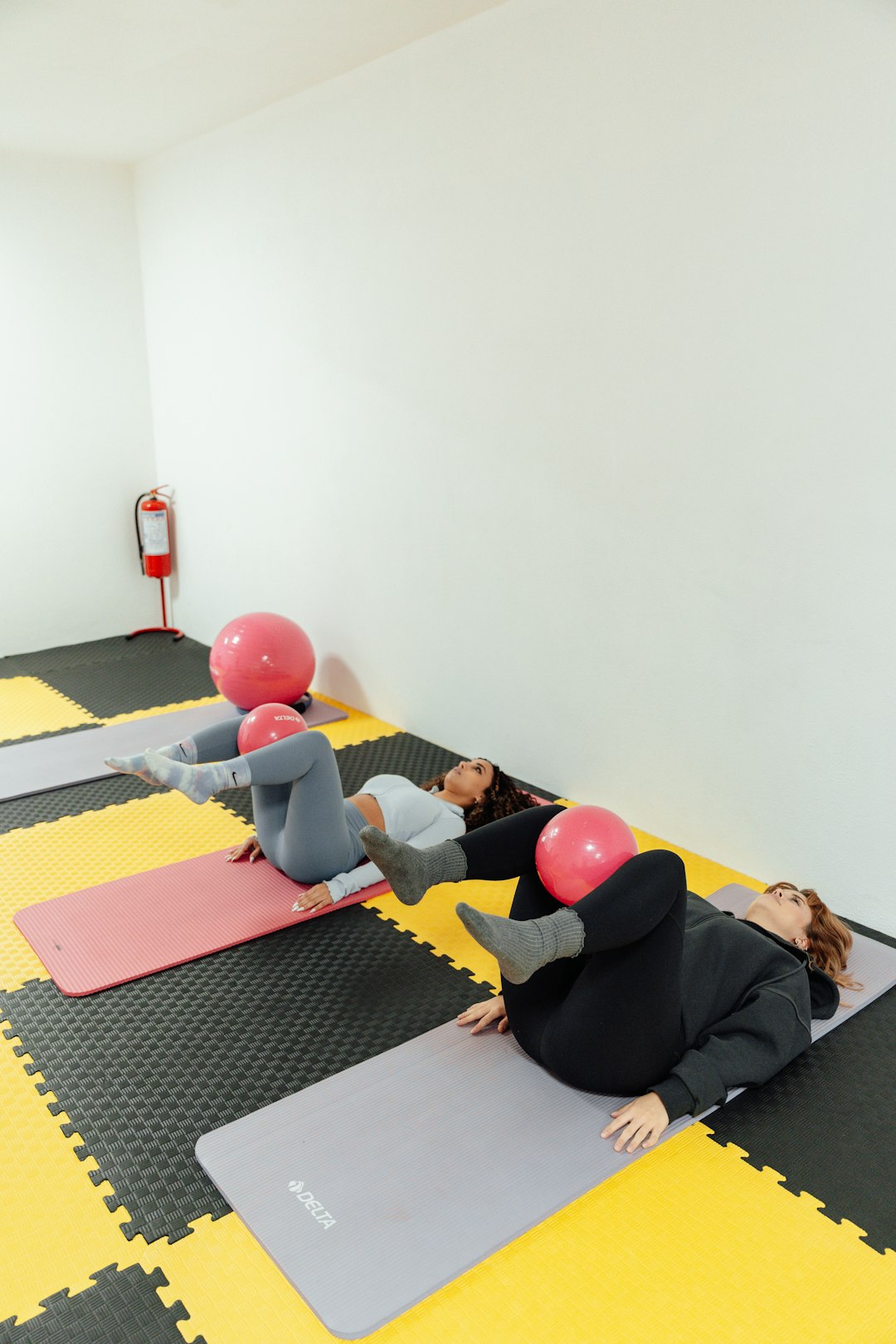 a-group-of-people-doing-yoga-in-a-room-pglqu8pffrg