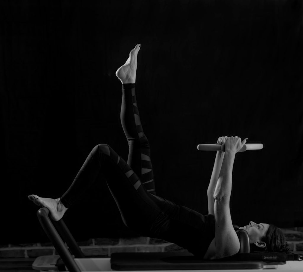 woman-in-black-pants-and-black-boots-lying-on-black-wooden-bench-gywi6wetdxy
