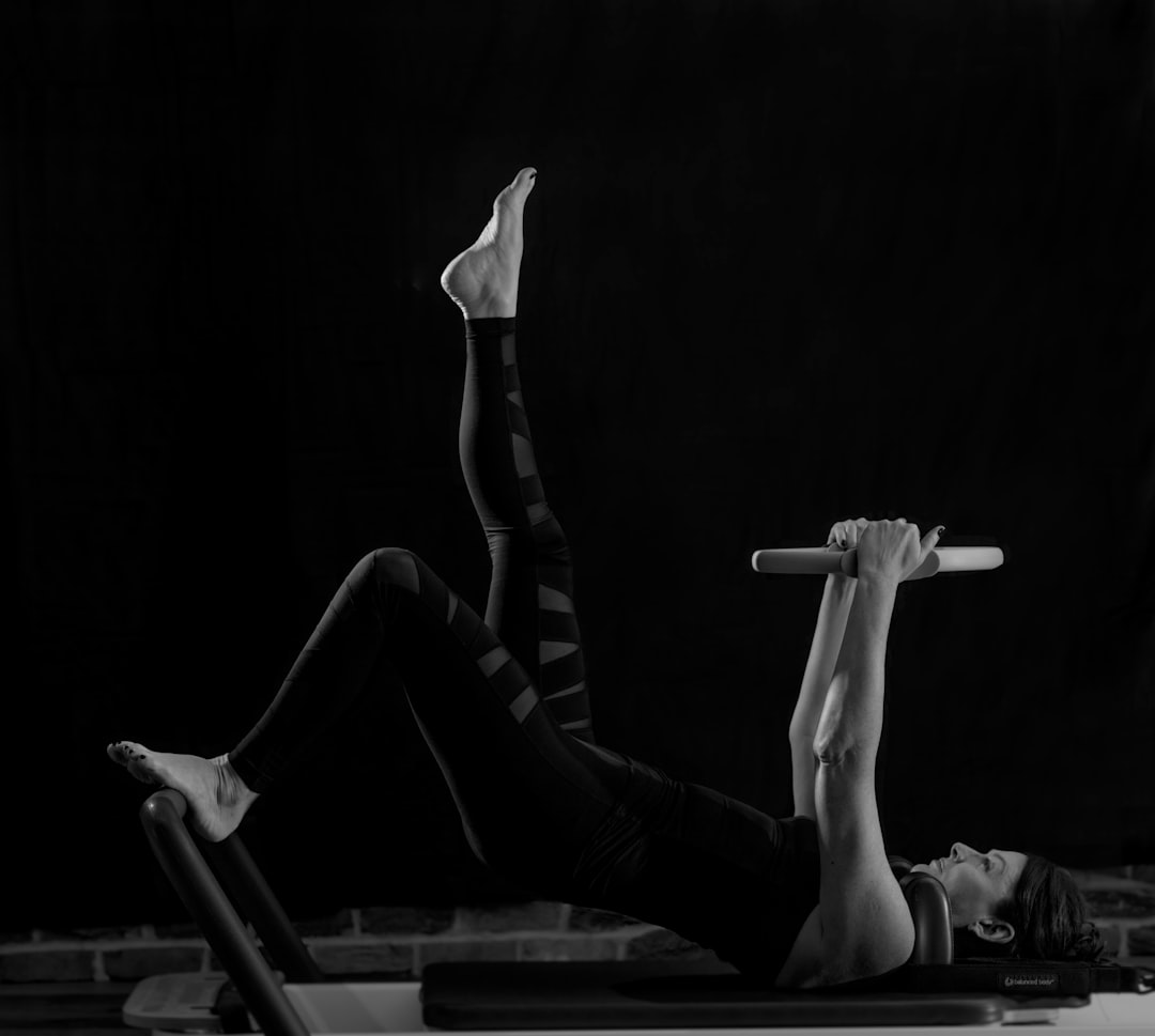 woman-in-black-pants-and-black-boots-lying-on-black-wooden-bench-gywi6wetdxy
